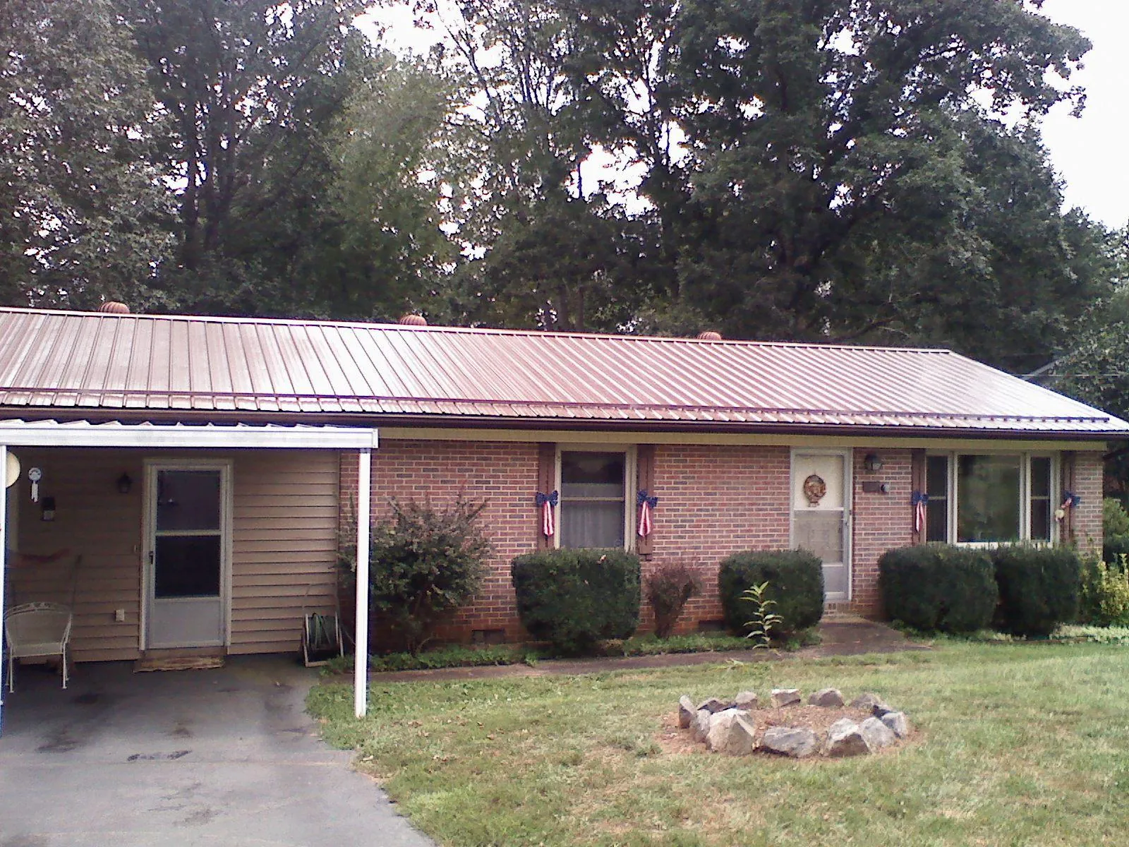 Bronze metal roof and carport on a brick ranch home — Roof Repair work by our crew in Aumsville